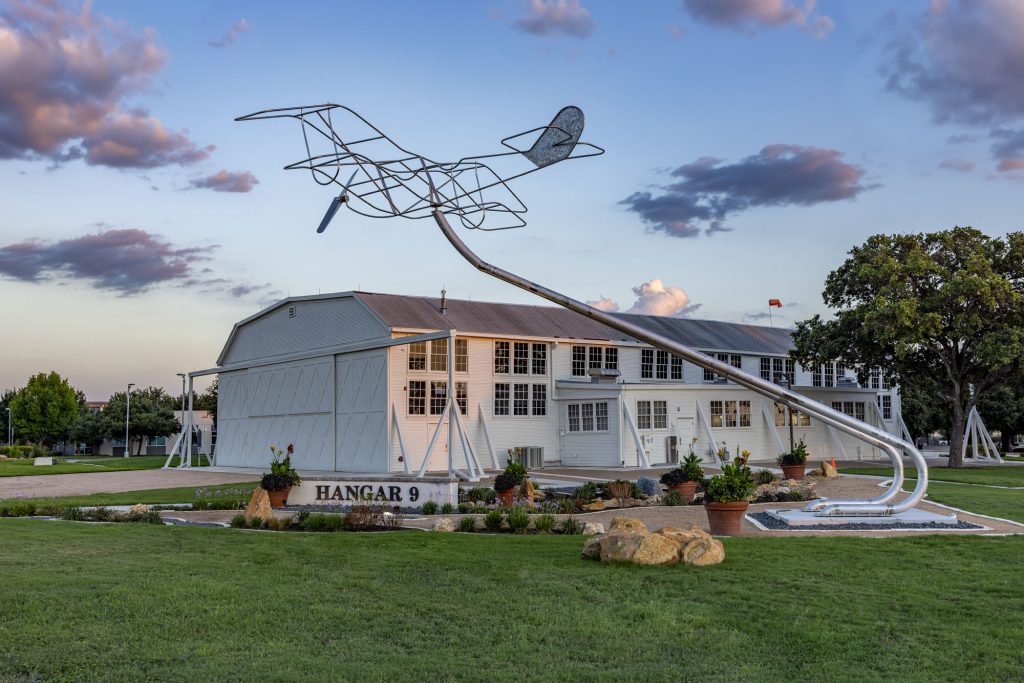 Large metal sculpture titles "The Beginning" installed at Brooks city-base in San Anotnio Texas by James Hetherington 2024